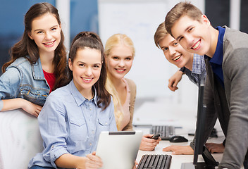 Image showing students with computer monitor and tablet pc