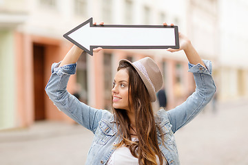 Image showing girl showing direction with arrow in the city