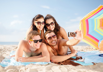 Image showing group of people taking picture with smartphone