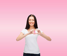 Image showing smiling woman with pink cancer awareness ribbon