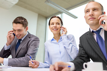 Image showing business team with smartphones having conversation