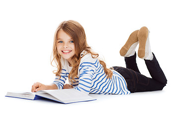 Image showing smiling little student girl lying on the floor