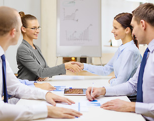 Image showing two businesswomen shaking hands in office