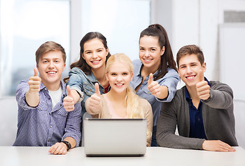 Image showing smiling students with laptop showing thumbs up