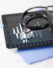 Image showing tablet pc, stethoscope and electrocardiogram