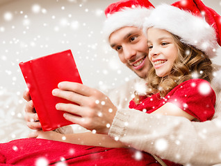 Image showing smiling father and daughter reading book