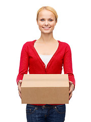 Image showing smiling woman in casual clothes with parcel box