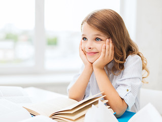 Image showing student girl writing in notebook at school