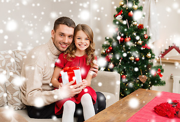 Image showing smiling father and daughter holding gift box