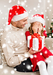 Image showing smiling daughter waiting for a present from father