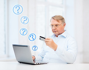 Image showing old man with laptop and credit card at home