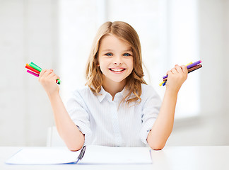 Image showing smiling girl showing colorful felt-tip pens