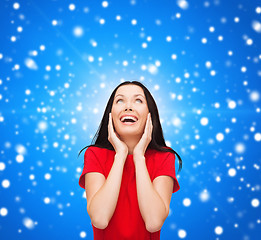 Image showing amazed laughing young woman in red dress