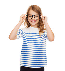 Image showing smiling cute little girl with black eyeglasses