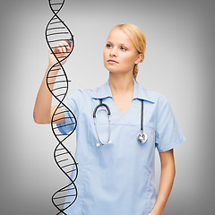 Image showing focused doctor or nurse drawing dna molecule