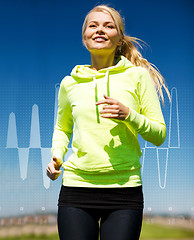 Image showing smiling woman jogging outdoors