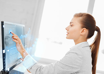 Image showing smiling businesswoman with touchscreen in office