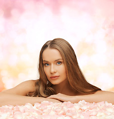 Image showing woman with long hair and rose petals