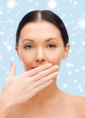 Image showing beautiful woman covering her mouth