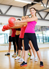 Image showing group of smiling people working out with ball