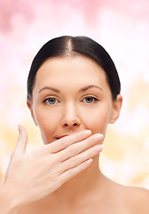 Image showing beautiful woman covering her mouth