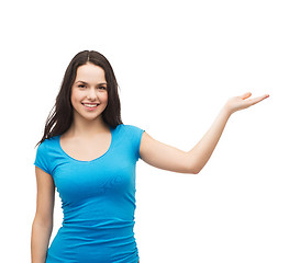 Image showing teenager holding something on the palm of her hand