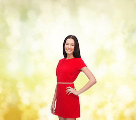 Image showing smiling young woman in red dress