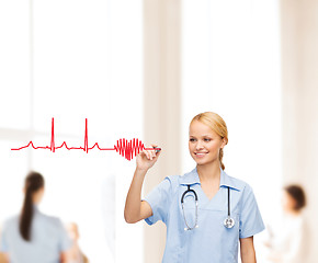 Image showing smiling doctor or nurse drawing electrocardiogram