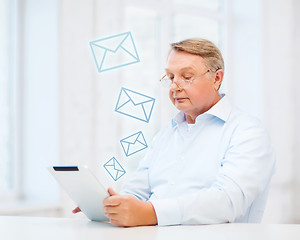 Image showing old man with tablet computer at home