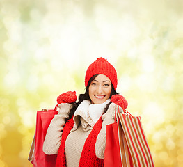 Image showing smiling woman in warm clothers with shopping bags