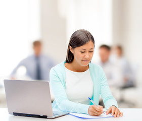 Image showing asian businesswoman with laptop and documents