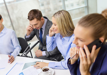 Image showing business team with smartphones having conversation