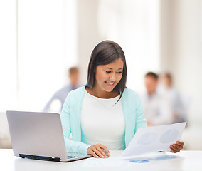 Image showing asian businesswoman with laptop and documents