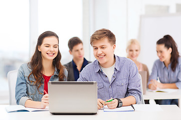 Image showing students with laptop and notebooks at school