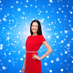 Image showing smiling young woman in red dress