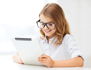 Image showing smiling girl in glasses with tablet pc at school