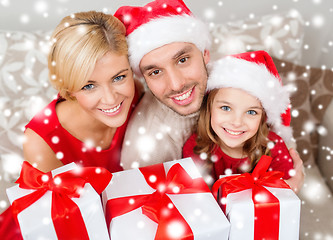 Image showing smiling family holding many gift boxes