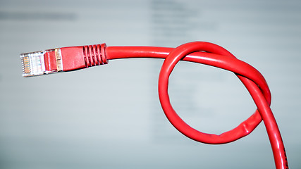 Image showing red networking cable with a knot