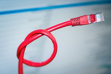 Image showing red networking cable with a knot