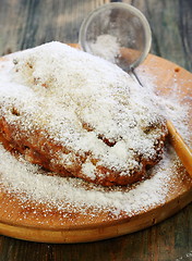 Image showing Christmas stollen decorated with powdered sugar.