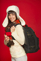 Image showing Winter woman tourist holding credit card