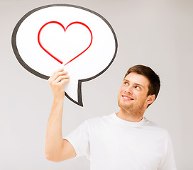 Image showing smiling young man with text bubble and heart in it