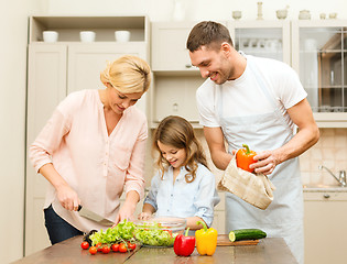 Image showing happy family making dinner in kitchen