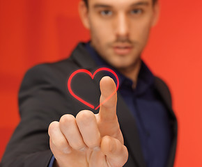 Image showing handsome man in suit pressing virtual button