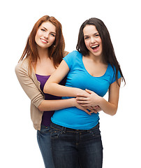 Image showing two laughing girls hugging