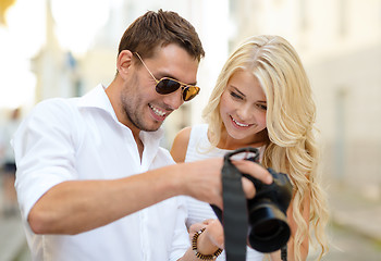 Image showing smiling couple with photo camera