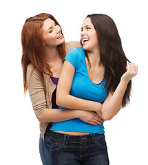 Image showing two laughing girls looking at each other
