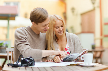 Image showing couple with map, camera, city guide and coffee