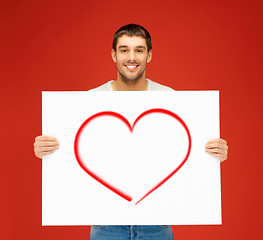 Image showing handsome man with big white board and heart on it