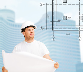 Image showing male architect in helmet looking at blueprint